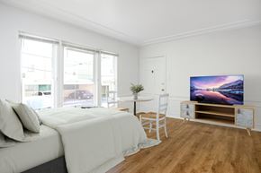 Beverly Hills triplex for rent - a bedroom with a bed and a tv on a table