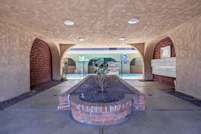 Van Nuys apartment for rent - a courtyard with a fire place and a pool in the background