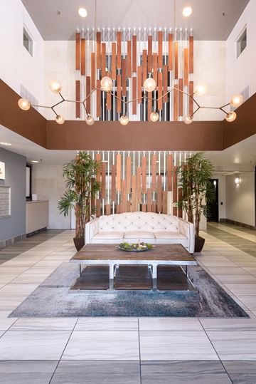 Los Angeles apartment for rent - a living room with a large white couch and a chandelier