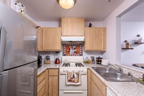 Fontana apartment for rent - a kitchen with white appliances and wooden cabinets