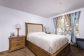 Fontana apartment for rent - a bedroom with a bed and a dresser and a window