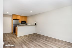 Venice apartment for rent - A kitchen with wooden cabinets and a white countertop.