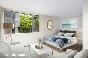 Venice apartment for rent - A modern bedroom with a large bed and a view of the outdoors.