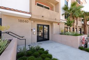 Reseda apartment for rent - the entrance to a building with a glass door and stairs