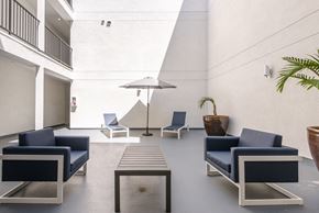 Reseda apartment for rent - a lounge area with blue chairs and a coffee table