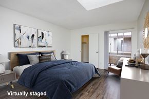 Los Angeles apartment for rent - A bedroom with a bed, nightstand, and a painting on the wall.