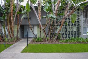 Los Angeles apartment for rent - a building with a sidewalk and trees in front of it