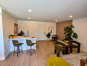 Venice apartment for rent - A living room with a bar area and a green chair.