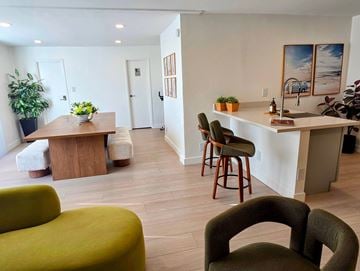 Venice apartment for rent - A living room with a green couch and a wooden table.
