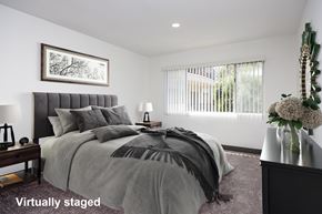 Pasadena apartment for rent - A bedroom with a large bed and a painting on the wall.