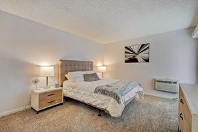 Santa Ana apartment for rent - a bedroom with a bed and a dresser with a nightstand