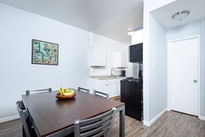 Long Beach apartment for rent - A dining room with a wooden table and chairs and a painting on the wall.