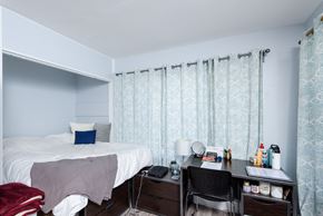 Long Beach apartment for rent - A bedroom with a bed, desk, and chair.