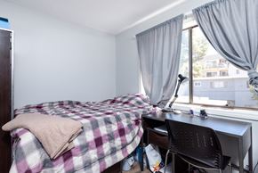 Long Beach apartment for rent - A bedroom with a bed, desk, and chair.