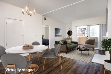 Los Angeles apartment for rent - A modern living room with a white table and grey chairs.