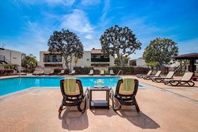 Carson apartment for rent - a swimming pool with lounge chairs and a coffee table