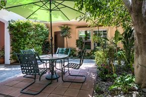 Beverly Hills apartment for rent - a patio with a table and chairs and an umbrella