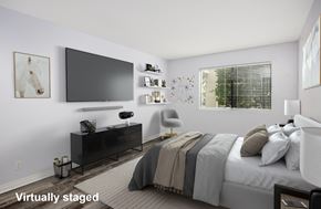 Glendale apartment for rent - A bedroom with a bed, chair, and a television.