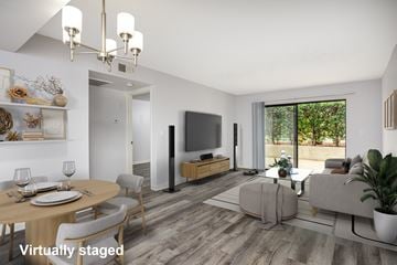 Glendale apartment for rent - A modern living room with a dining table set for two and a flat screen TV.