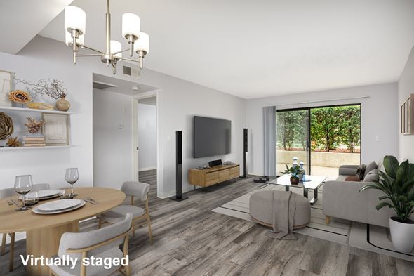 Glendale apartment for rent - A modern living room with a dining table set for two and a flat screen TV.