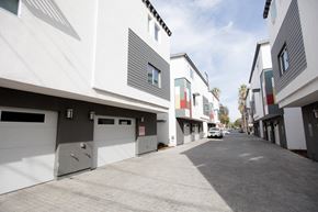 Los Angeles apartment for rent - A row of modern houses with garages on the side.