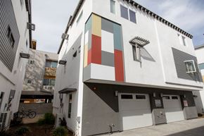 Los Angeles apartment for rent - A white building with a red, green, and blue square on the side.