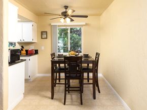 San Pedro apartment for rent - a dining room with a table and chairs and a ceiling fan