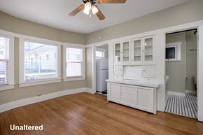 Long Beach apartment for rent - A kitchen with white cabinets and a wooden floor.
