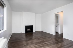 Temple City apartment for rent - an empty living room with white walls and a fireplace