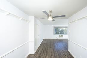 North Hollywood apartment for rent - a living room with white walls and a ceiling fan