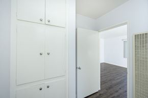 North Hollywood apartment for rent - a bedroom with white cabinets and a door to a closet