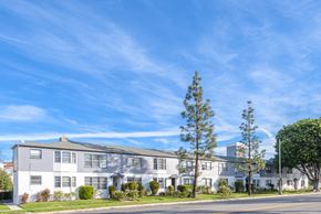 Los Angeles apartment for rent - an apartment building on the corner of a street with a blue sky