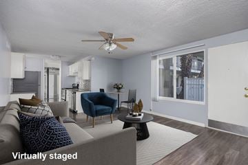 Long Beach apartment for rent - A living room with a grey couch and a blue chair.