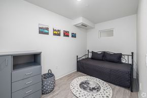 Los Angeles apartment for rent - A bedroom with a bed, dresser, and pictures on the wall.