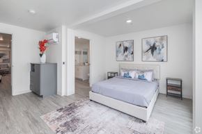 Los Angeles apartment for rent - A bedroom with a large bed and a grey cabinet.