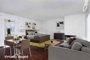 Canoga Park apartment for rent - A bedroom with a bed, dresser, and a couch.