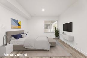 Los Angeles apartment for rent - A bedroom with a bed, a couch, a television, and a painting on the wall.