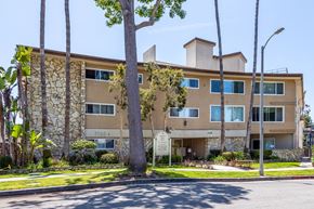 Los Angeles apartment for rent - a large apartment building with a sign in front of it