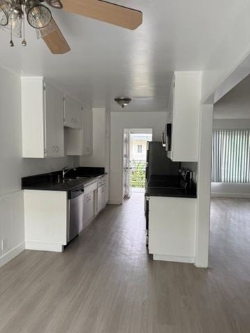 Los Angeles apartment for rent - A kitchen with white cabinets and black countertops.