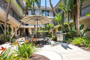 Los Angeles apartment for rent - a patio with a table and chairs and an umbrella