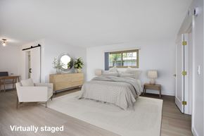 Los Angeles apartment for rent - A bedroom with a bed, nightstand, chair, and a window.