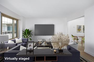 Los Angeles apartment for rent - A modern living room with a dark coffee table and a large screen on the wall.