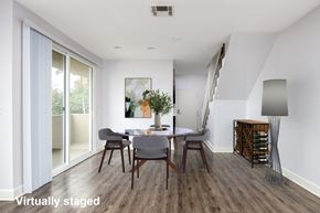 Los Angeles townhouse for rent - A modern dining room with a wooden floor and white walls.