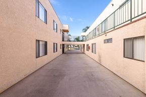 Inglewood apartment for rent - a corridor between two buildings on a sunny day