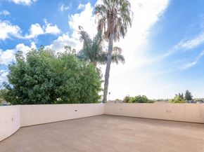 Inglewood apartment for rent - a large patio with palm trees and trees in the background