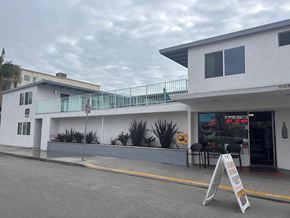 Long Beach apartment for rent - A white building with a red sign on the door.