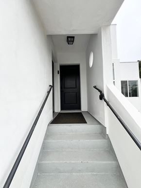 Los Angeles apartment for rent - the entrance to a building with stairs and a black door