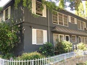 West Hollywood apartment for rent - a black house with white windows and a white fence