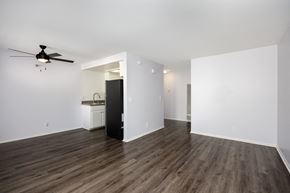 Hawthorne apartment for rent - an empty living room with white walls and a ceiling fan