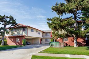 Arcadia apartment for rent - a street view of an apartment building with a white fence